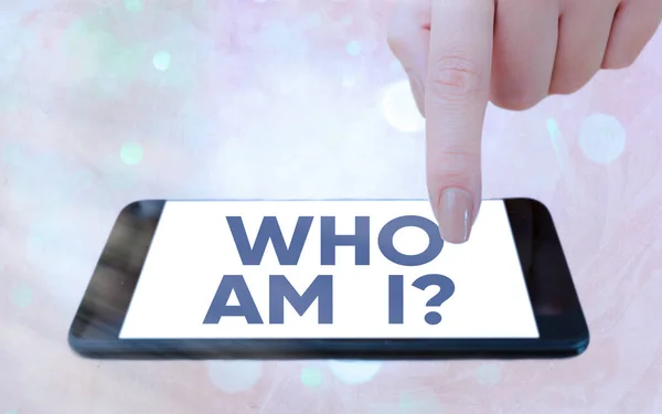 Text sign showing Who Am I Question. Conceptual photo asking about selfidentity or an individualal purpose in life Modern gadgets with white display screen under colorful bokeh background. — Stock Photo, Image