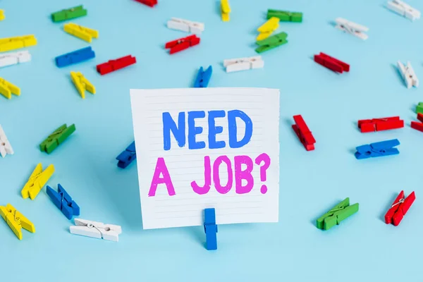 Word writing text Need A Job Question. Business concept for to recruit an individual for specific duty role or function Colored clothespin papers empty reminder blue floor background office pin.