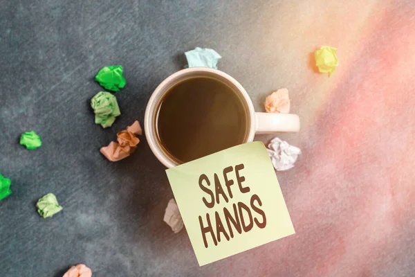 Writing note showing Safe Hands. Business photo showcasing Ensuring the sterility and cleanliness of the hands for decontamination Paper accessories with smartphone arranged on different background.