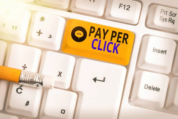 Text sign showing Pay Per Click. Conceptual photo internet marketing in which payment is based on clickthrough Different colored keyboard key with accessories arranged on empty copy space. — Stock Photo, Image