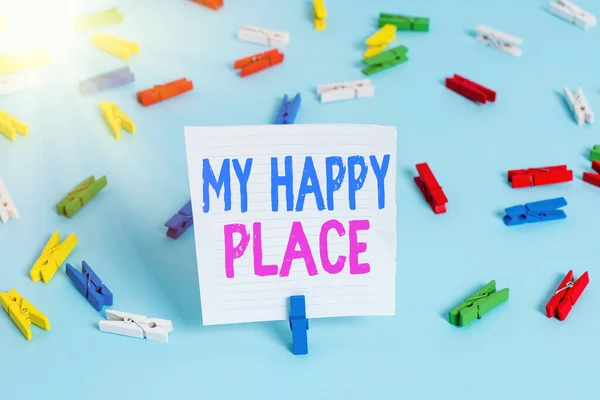 Word writing text My Happy Place. Business concept for something nice has happened or they feel satisfied with life Colored clothespin papers empty reminder blue floor background office pin.