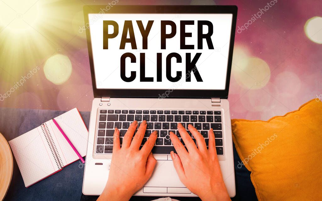 Conceptual hand writing showing Pay Per Click. Business photo showcasing internet marketing in which payment is based on clickthrough Modern gadgets white screen under colorful bokeh background.