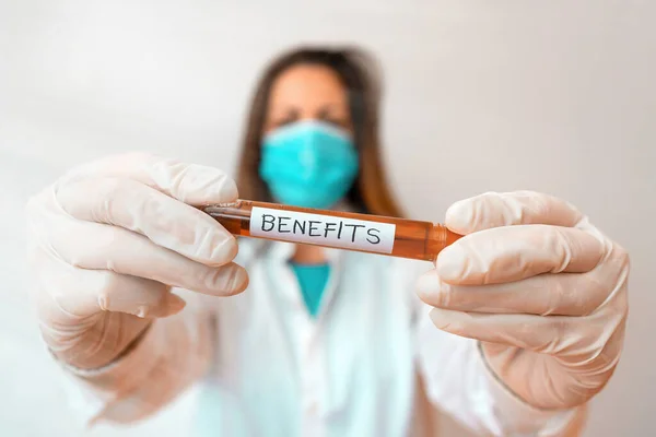 Writing note showing Benefits. Business photo showcasing produces helpful results or effects that promote wellbeing Laboratory blood test sample for medical diagnostic analysis. — Stock Photo, Image