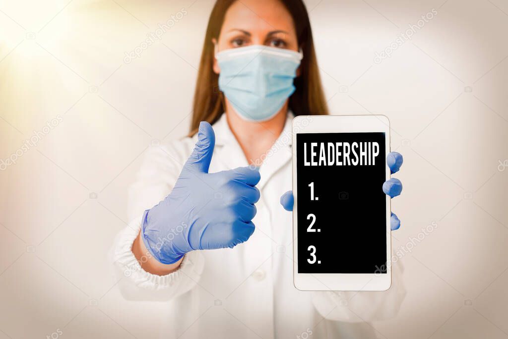 Conceptual hand writing showing Leadership. Business photo showcasing ability to guide others without force into direction or decision Laboratory technician featuring paper accessories smartphone.