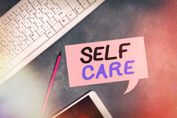 Handwriting text writing Self Care. Concept meaning the practice of taking action to preserve or improve one s is health Paper accesories with digital smartphone arranged on different background. — Stock Photo, Image