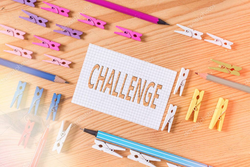 Conceptual hand writing showing Challenge. Business photo text process of provoking or testing physiological activity by exposure Colored crumpled papers wooden floor background clothespin.