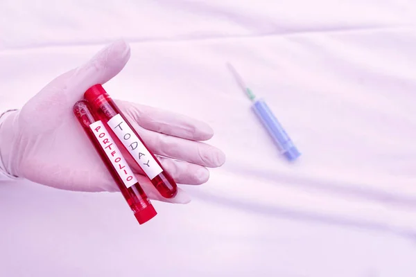 Handwriting text writing Portfolio. Concept meaning securities held by an investor, paper held by a financial house Extracted blood sample vial ready for medical diagnostic examination.