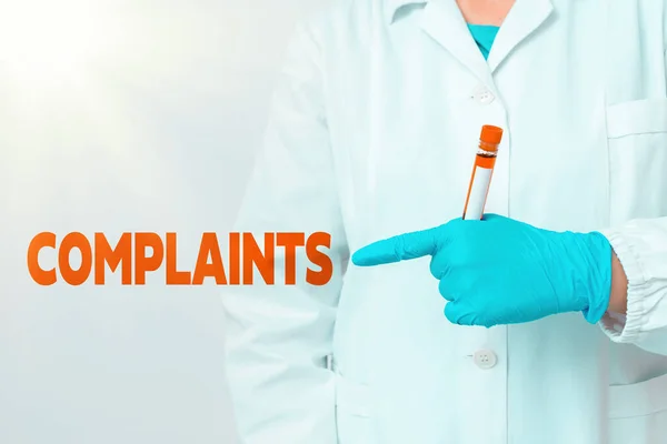 Handwriting text writing Complaints. Concept meaning something that is the cause or subject of protest or outcry Laboratory blood test sample shown for medical diagnostic analysis result. — Stock Photo, Image