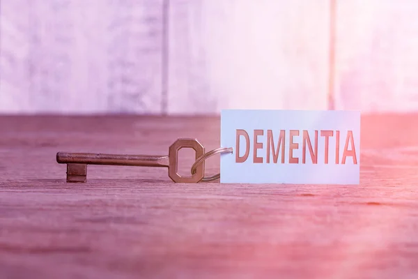 Writing note showing Dementia. Business photo showcasing usually, a progressive condition marked by multiple deficits Paper accessories with smartphone arranged on different background. — Stock Photo, Image