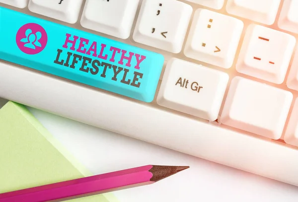 Word writing text Healthy Lifestyle. Business concept for way of living that lowers the risk of being seriously ill Different colored keyboard key with accessories arranged on empty copy space. — Stock Photo, Image