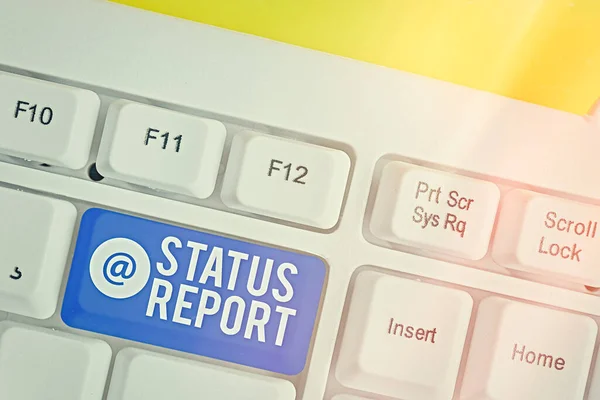 Writing note showing Status Report. Business photo showcasing summarizes the particular situation as of a stated period Colored keyboard key with accessories arranged on empty copy space.