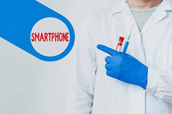 Text sign showing Smartphone. Conceptual photo the mobile phone that performs many of the functions of computer Displaying Empty Sticker Paper Accessories Smartphone With Medical Gloves On.
