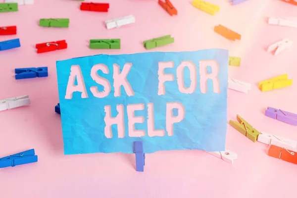 Conceptual hand writing showing Ask For Help. Business photo showcasing put a question or seek an answer or assistance from someone Colored clothespin papers empty reminder pink floor office.