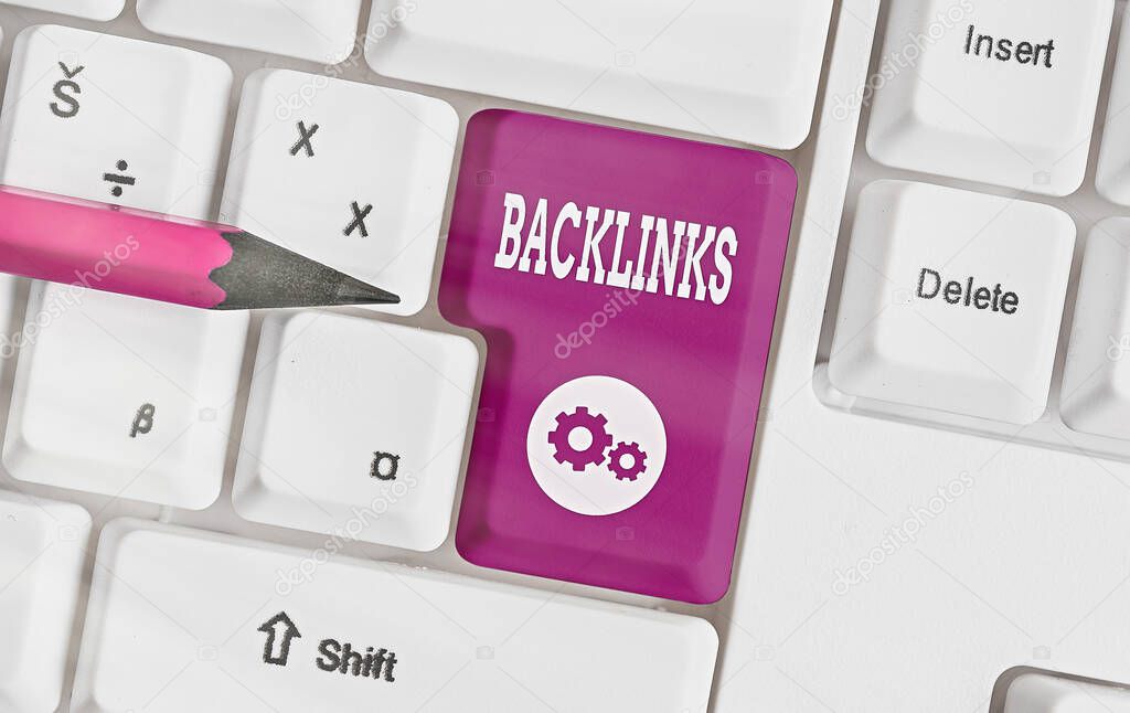 Writing note showing Backlinks. Business photo showcasing links from one website to a page on another website or page Colored keyboard key with accessories arranged on empty copy space.
