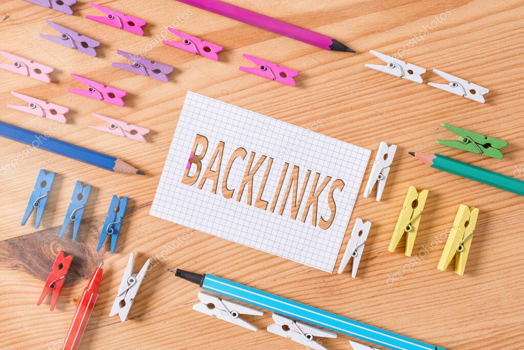 Conceptual hand writing showing Backlinks. Business photo text links from one website to a page on another website or page Colored crumpled papers wooden floor background clothespin.