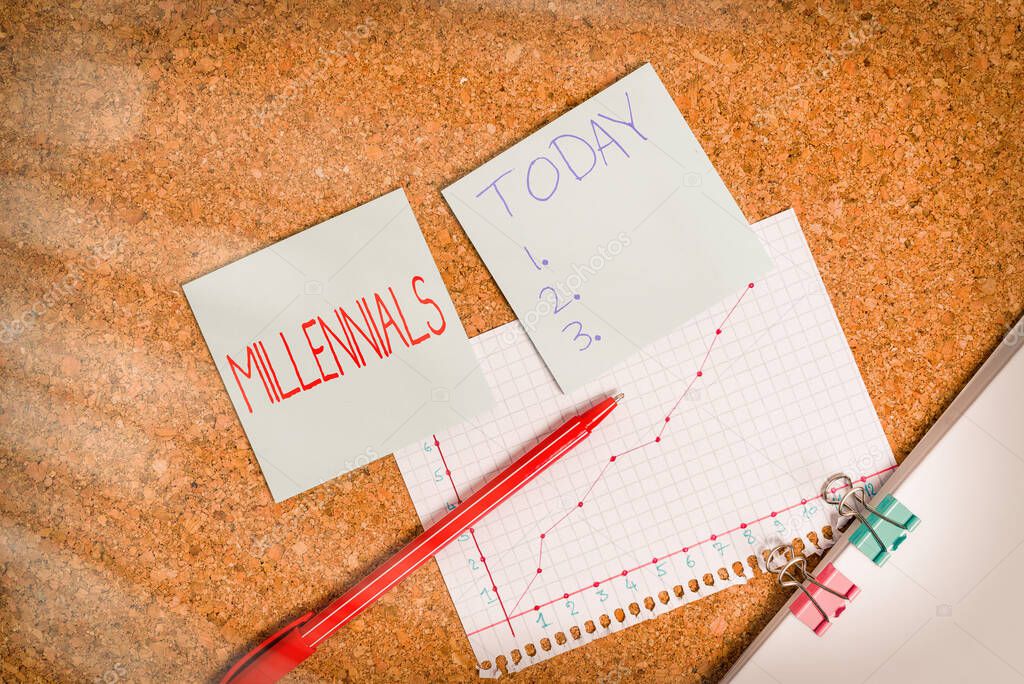 Conceptual hand writing showing Millennials. Business photo text an individual reaching young adulthood in the early 21st century Desk notebook paper office paperboard study supplies chart.