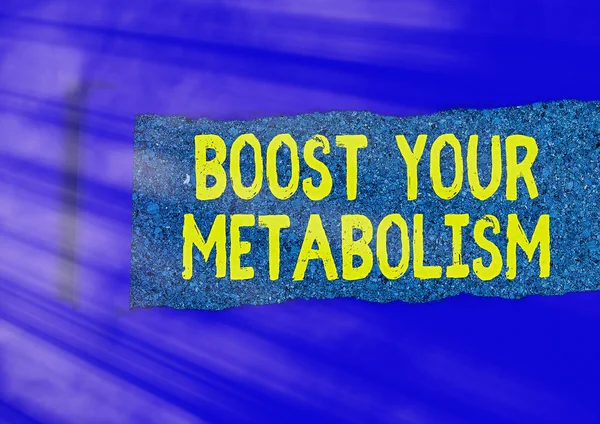 Writing note showing Boost Your Metabolism. Business photo showcasing body process uses to make and burn energy from food Rolled ripped torn cardboard above a wooden classic table.
