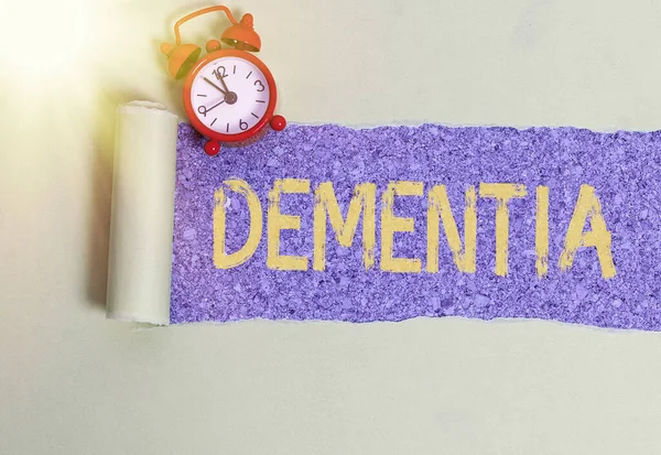 Handwriting text writing Dementia. Concept meaning usually, a progressive condition marked by multiple deficits Rolled ripped torn cardboard placed above a wooden classic table backdrop. — Stock Photo, Image