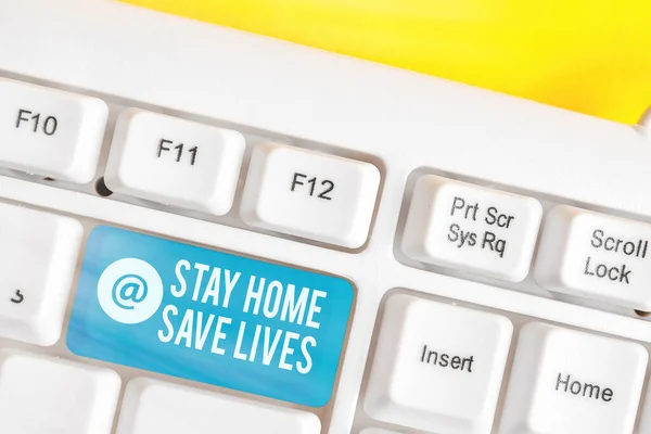 Stay Home Save Lives 'ı gösteren bir not yazıyorum. İş fotoğrafı gösterimi, evi terk etmeyerek hasta sayısını azaltıyor. Boş kopya alanına yerleştirilmiş aksesuarlarla birlikte renkli klavye anahtarı.. — Stok fotoğraf