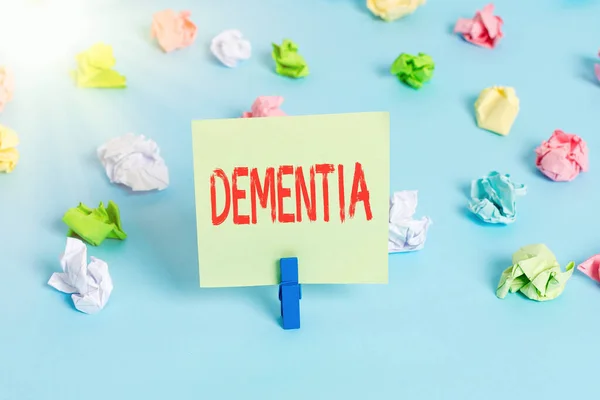 Word writing text Dementia. Business concept for usually, a progressive condition marked by multiple deficits Colored crumpled papers empty reminder blue floor background clothespin. — Stock Photo, Image