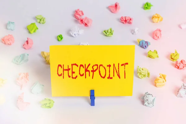 Handwriting text Checkpoint. Concept meaning manned entrance, where travelers are subject to security checks Colored crumpled papers empty reminder white floor background clothespin. — Stock Photo, Image