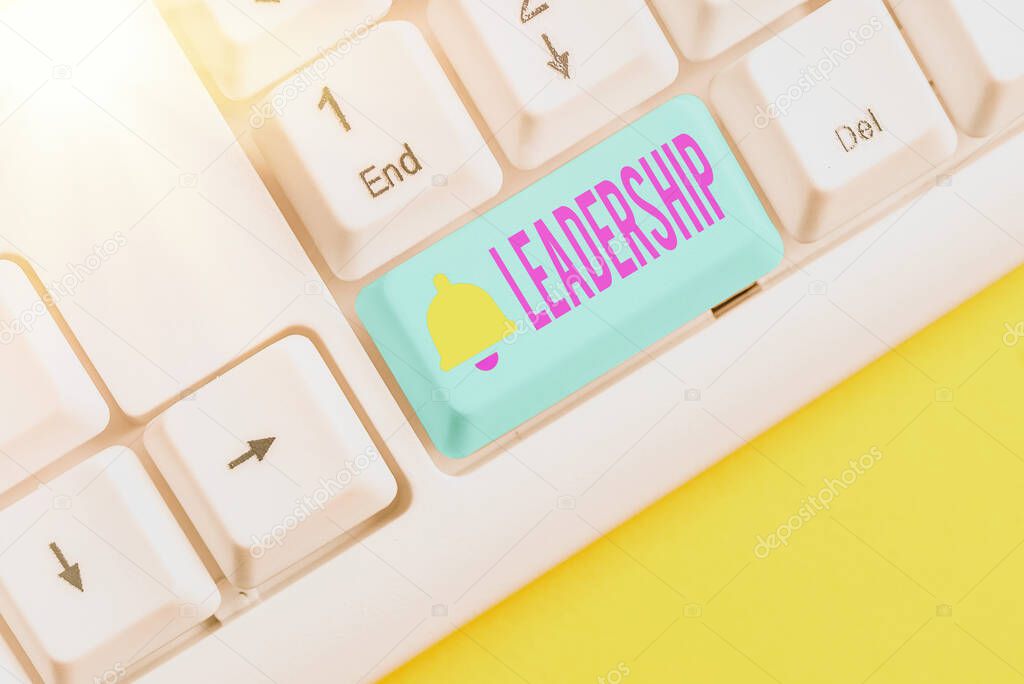 Handwriting text writing Leadership. Concept meaning ability to guide others without force into direction or decision Different colored keyboard key with accessories arranged on empty copy space.