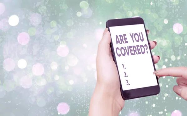 Text sign showing Are You Covered Question. Conceptual photo asking if they had insurance in work or life Modern gadgets with white display screen under colorful bokeh background. — Stock Photo, Image