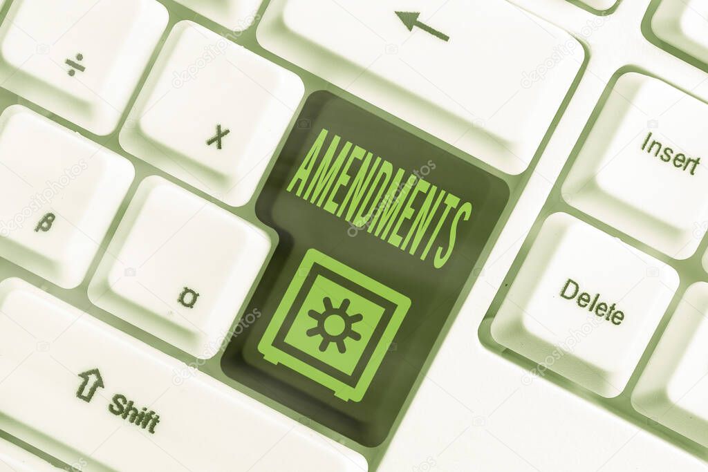 Text sign showing Amendments. Conceptual photo process of amending a law or document by parliamentary. Different colored keyboard key with accessories arranged on empty copy space.