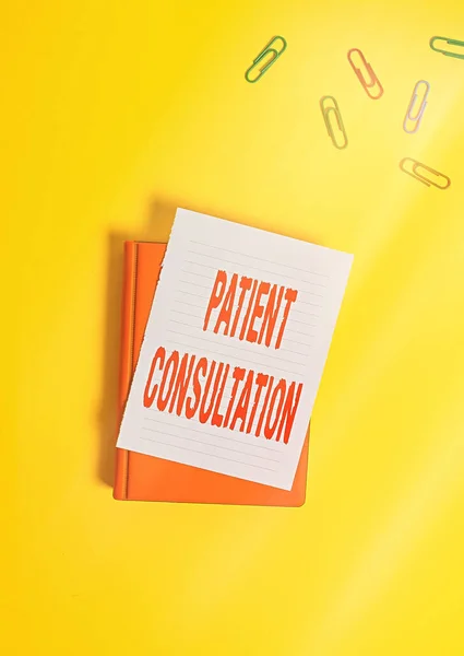 Text sign showing Patient Consultation. Conceptual photo examinings discuss a patient and his or her condition Paper clips with blank papers for text messages.