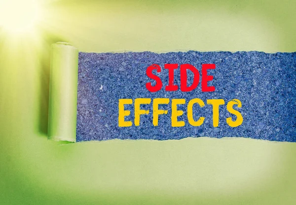 Handwriting text Side Effects. Concept meaning Typically undesirable effect of a drug or medical treatment Rolled ripped torn cardboard placed above a wooden classic table backdrop.