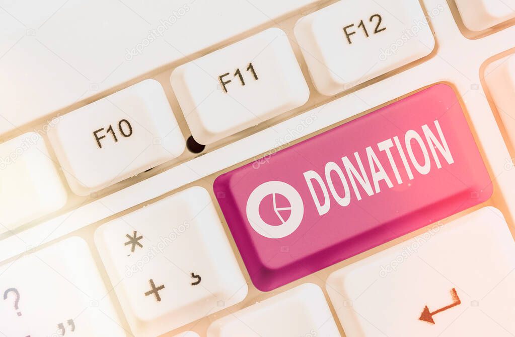 Text sign showing Donation. Conceptual photo the act or an instance of donating such as the making of a gift Different colored keyboard key with accessories arranged on empty copy space.