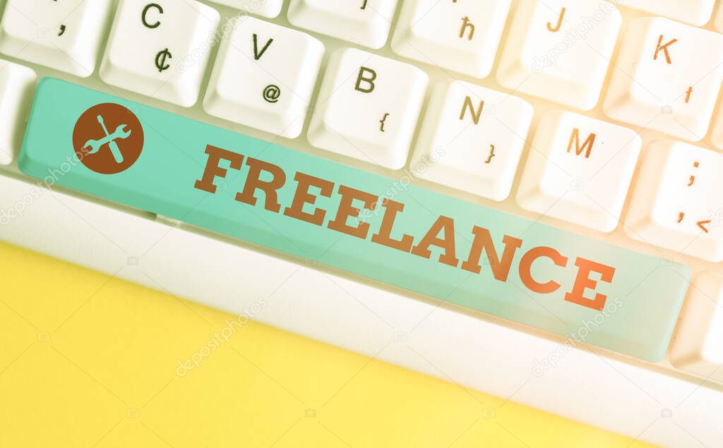 Handwriting text Freelance. Concept meaning an individual who pursues a profession without a longterm commitment Different colored keyboard key with accessories arranged on empty copy space.