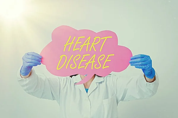 Conceptual hand writing showing Heart Disease. Business photo text A type of disease that affects the heart or blood vessels Laboratory technician featuring empty paper accessories smartphone. — Stock Photo, Image