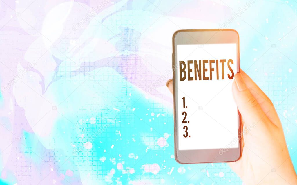 Word writing text Benefits. Business concept for produces helpful results or effects that promote wellbeing Modern gadgets with white display screen under colorful bokeh background.