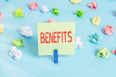 Kelime yazma metni faydaları. Refahı teşvik eden yararlı sonuçlar veya efektler üretmek için iş konsepti Renkli buruşmuş kağıtlar boş hatırlatıcı mavi zemin çamaşır mandalı.