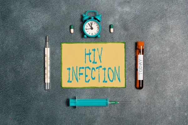 Handwriting text Hiv Infection. Concept meaning A disease of the immune system due to the infection of HIV Extracted blood sample vial with medical accessories ready for examination.