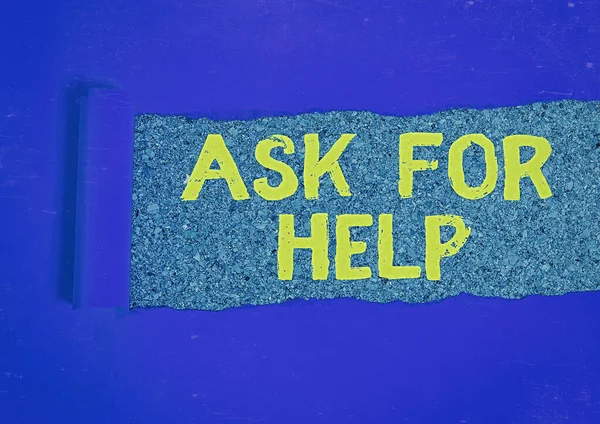 Writing note showing Ask For Help. Business photo showcasing put a question or seek an answer or assistance from someone Rolled ripped torn cardboard above a wooden classic table.