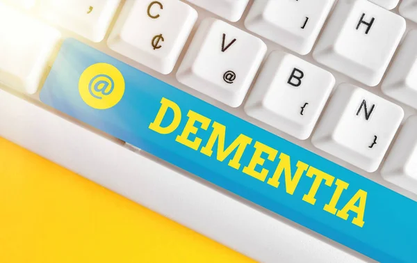 Writing note showing Dementia. Business photo showcasing usually, a progressive condition marked by multiple deficits Colored keyboard key with accessories arranged on empty copy space. — Stock Photo, Image