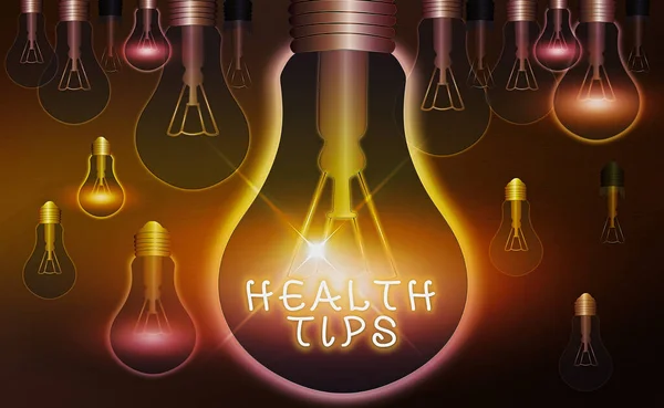 Word writing text Health Tips. Business concept for advice or information given to be helpful in being healthy Realistic colored vintage light bulbs, idea sign solution thinking concept.