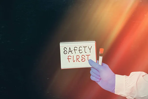 Conceptual hand writing showing Safety First. Business photo showcasing used to say that the most important thing is to be safe Displaying Sticker Paper Accessories With Medical Gloves On. — Stock Photo, Image