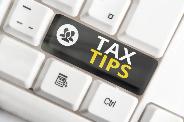 Writing note showing Tax Tips. Business photo showcasing compulsory contribution to state revenue levied by government Colored keyboard key with accessories arranged on empty copy space.