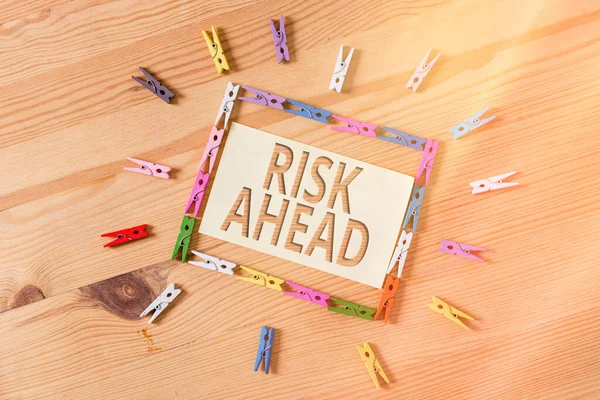 Word writing text Risk Ahead. Business concept for A probability or threat of damage, injury, liability, loss Colored clothespin papers empty reminder wooden floor background office. — Stock Photo, Image