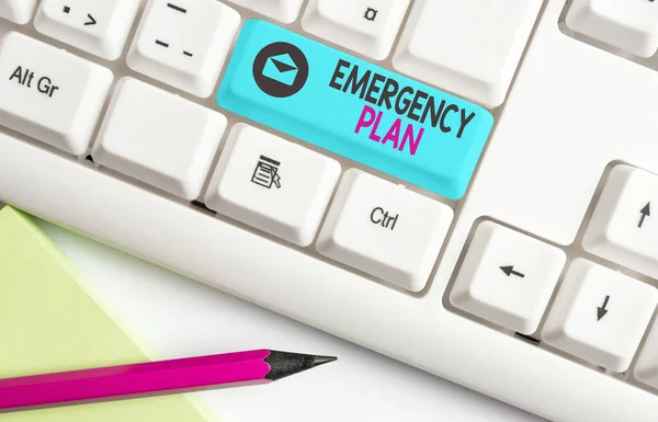 Handwriting text Emergency Plan. Concept meaning instructions that outlines what workers should do in danger Different colored keyboard key with accessories arranged on empty copy space. — Stock Photo, Image