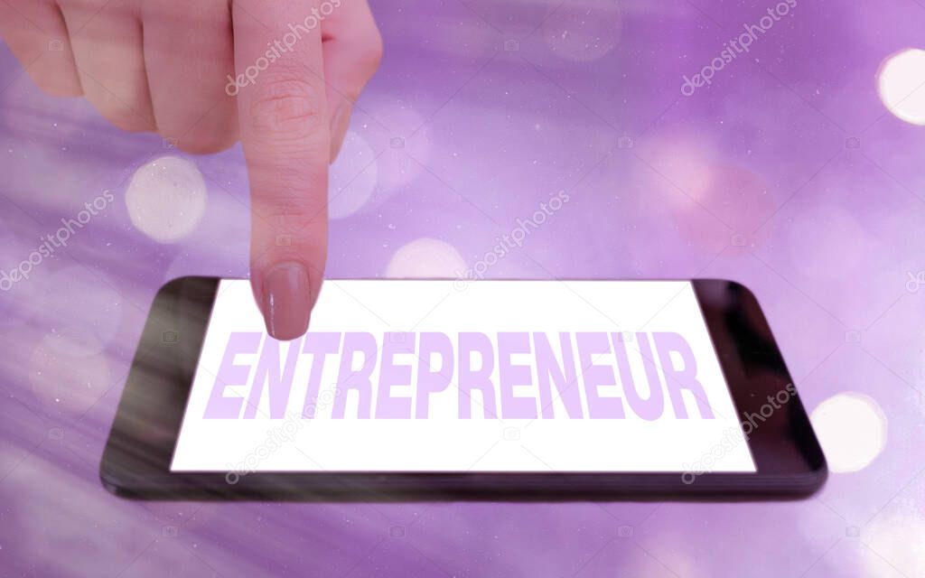Conceptual hand writing showing Entrepreneur. Business photo showcasing one who organizes and assumes the risks of a business Modern gadgets white screen under colorful bokeh background.