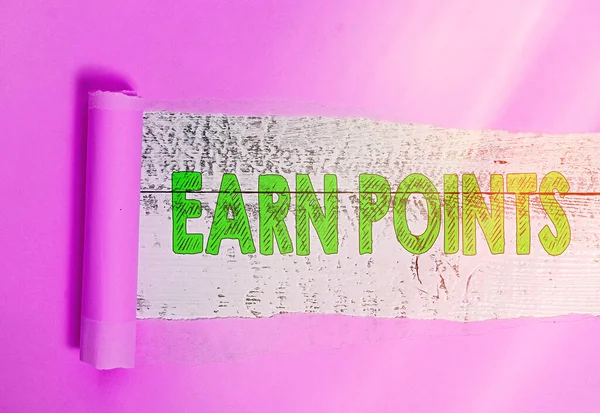 Text sign showing Earn Points. Conceptual photo getting praise or approval for something you have done Rolled ripped torn cardboard placed above a wooden classic table backdrop.
