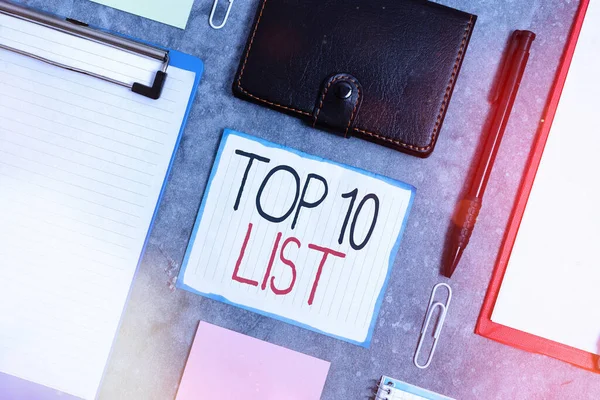 Handwriting text Top 10 List. Concept meaning the ten most important or successful items in a particular list Paper accesories with digital smartphone arranged on different background.