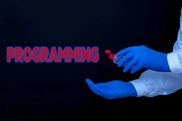 Conceptual hand writing showing Programming. Business photo text the process of preparing an instructional program for a device Displaying Sticker Paper Accessories With Medical Gloves On. — Stock Photo, Image