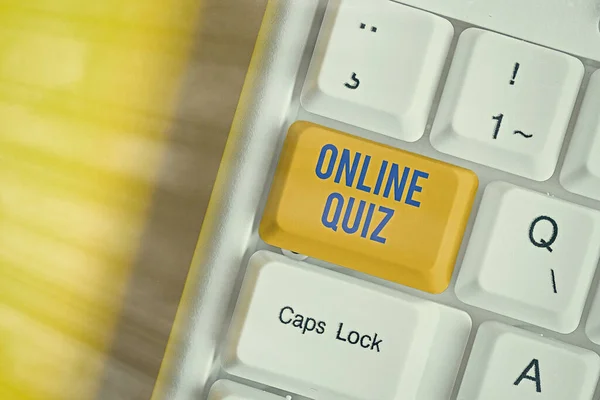 Text sign showing Online Quiz. Conceptual photo game or a mind sport that are published on the Internet Different colored keyboard key with accessories arranged on empty copy space.