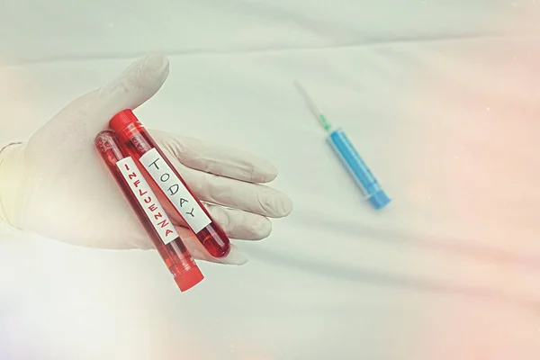Handwriting text writing Influenza. Concept meaning any of various respiratory infections of undetermined cause Extracted blood sample vial ready for medical diagnostic examination. — Stock Photo, Image