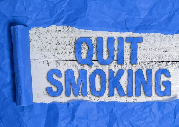 Text sign showing Quit Smoking. Conceptual photo Discontinuing or stopping the use of tobacco addiction Rolled ripped torn cardboard placed above a wooden classic table backdrop. — Stock Photo, Image